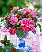 Small arrangement of pink (rose), duchesnea (mock strawberry)