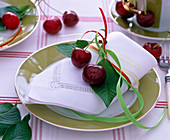 Prunus (cherries) on folded cloth napkin