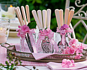 Hydrangea, flowers on glasses with white cutlery on tray