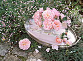 Small roses bouquet in crystal bowl on metal tray