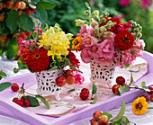 Small bouquets of Antirrhinum (snapdragons), Zinnia (zinnias) in vases