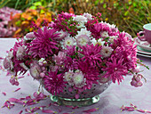 Arrangement of pink autumn chrysanthemums in a colander