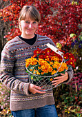 Young woman with chrysanthemum (autumn chrysanthemum)