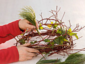 Advent wreath with red balls, twigs and ivy (3/6)