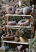 Wreaths and balls with larix cones, star anise, basket with pinus