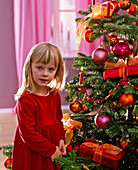 Girl in front of Abies nordmanniana as a Christmas tree