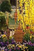 Self-woven decorative objects made of Salix (willow) in bed with Erysimum