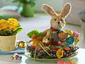 Easter nest made of Salix (catkin willow) with stuffed bunny and chocolate Easter bunny