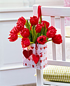 Tulipa (tulip) bouquet in a bag with hearts on backrest