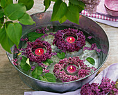 Wreaths of Syringa (lilac) floating around lanterns in water