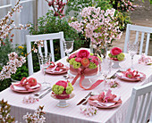 Table decoration with ranunculus, viburnum, prunus