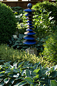 Sculpture made of blue clay discs with a ball as top