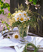 Small bouquet of Leucanthemum (spring daisies), Sambucus