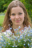 Woman with bouquet of Myosotis (forget-me-not)