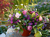 Autumn bouquet with pink (roses and rose hips), aster (autumn asters)