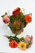 Bouquet of dahlias in a vase of leaves (5/6)