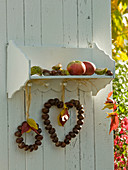 Small wooden shelf with aesculus (chestnut) heart and wreath