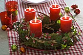 Advent wreath made of moss, decorated with small toadstools