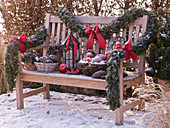 Wooden bench decorated with Christmas garland