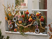 Basket jardiniere and vase in front of the window as feed station for birds