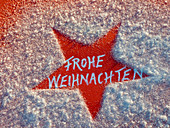 Red star in the snow with text 'Merry Christmas'.