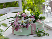 Oval box as a gift with small bouquet of Aquilegia (columbine)