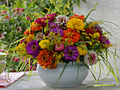 Colorful late summer arrangement in white cup