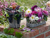Grapes and apples in basket, dahlia arrangement