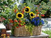 Autumn basket with sunflowers and perennials