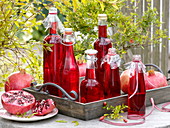 Homemade juice (syrup) from pomegranates (Punica) in bottles