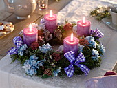 Unusual Advent wreath of mixed coniferous green with flowers