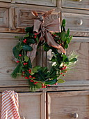 Winter wreath of Ilex (holly) and Pinus (silk pine)