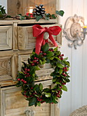 Wreath of holly hanging from a cupboard