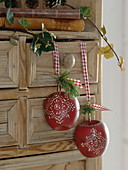 Deco apples made of wood with small tips of Pinus (pine) hung on shelf