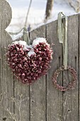 Staked heart and small wreath of Calluna (broom heather) on fence