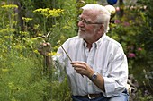 Man is happy about swallowtail on fennel