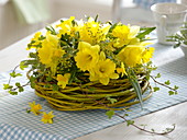 Yellow daffodil bouquet in wreath of dogwood branches
