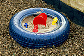 Blue PAINTED TYRE USED As A SANDPIT