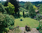 Long SHOT of THE Garden From THE HOUSE with 4 Taxus BACCATA 'FASTIGIATA', TWO CIRCULAR LAWNS, SHED AND COPPER Pot Washed TORQUOISE. THE White HOUSE, Sussex