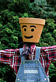 Designer Clare MATTHEWS: SCARECROW PROJECT: Shirt AND Denim DUNGARIES PLACED OVER POLES with TERRACOTTA Pot HEAD IN PLACE