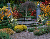 ENTRANCE TO PAVED Garden, SURROUNDED by AUTUMNAL BORDER, Designer: BRIAN CROSS, LAKEMOUNT, IRELAND