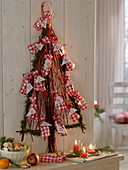Stylized Christmas tree made of twigs as an advent calendar