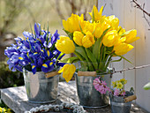 Spring bouquets in small tin buckets