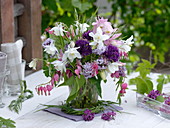 Spring bouquet from Aquilegia, Allium, Dicentra