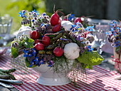 Table decoration with asparagus, radish and borage