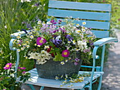 Herb bouquet in a wide metal tub