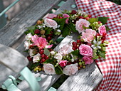 Wreath of pink (rose blossoms), currants, gooseberries (Ribes)