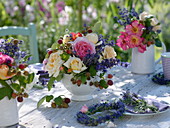 Summer table decoration with roses, lavender and raspberries