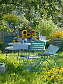 Table decoration with sunflowers under apple tree