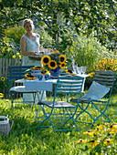 Table decoration with sunflowers under apple tree